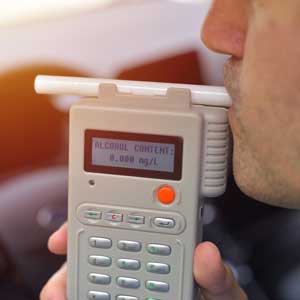 Man blowing in breathalyzer